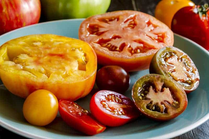 sliced heirloom tomatoes placed on a teal plate