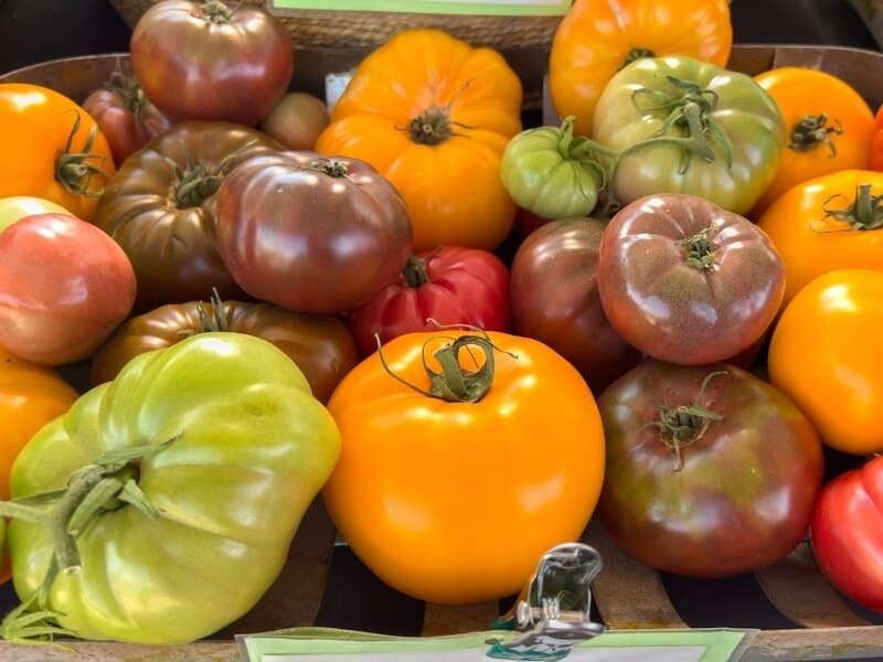 Variety of heirloom tomatoes stacked together